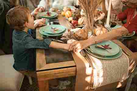 Thanksgiving dinner holding hands